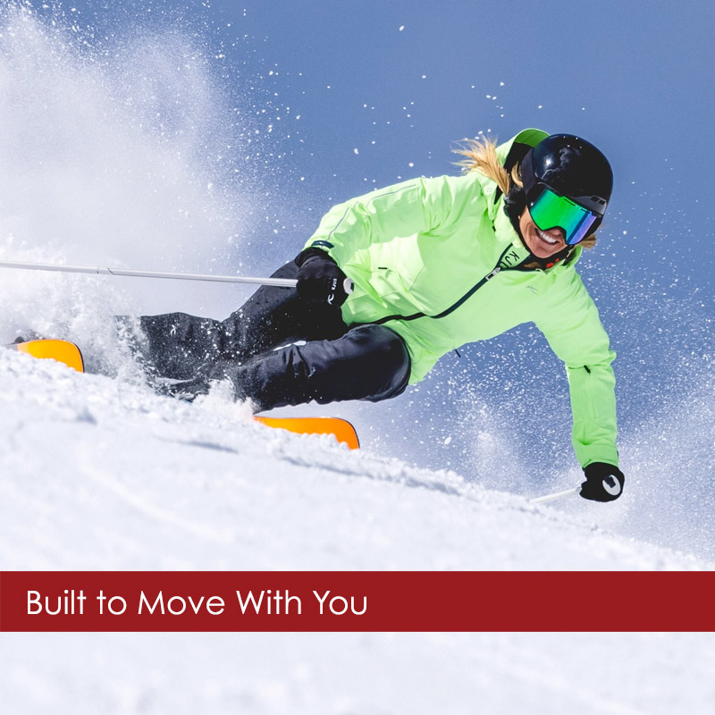 Kjus-womens-skiwear Woman wearing KJUS skiwear green ski jacket skiing on Aspen Highlands