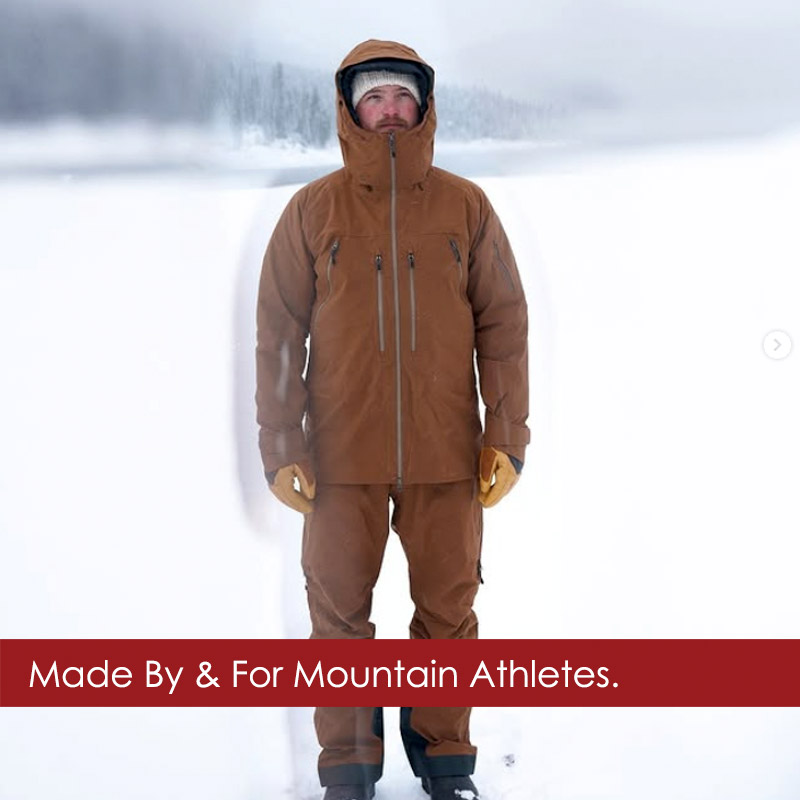 Beringia-ski-wear-man Man wearing Beringia ski jacket and ski pants standing on snow