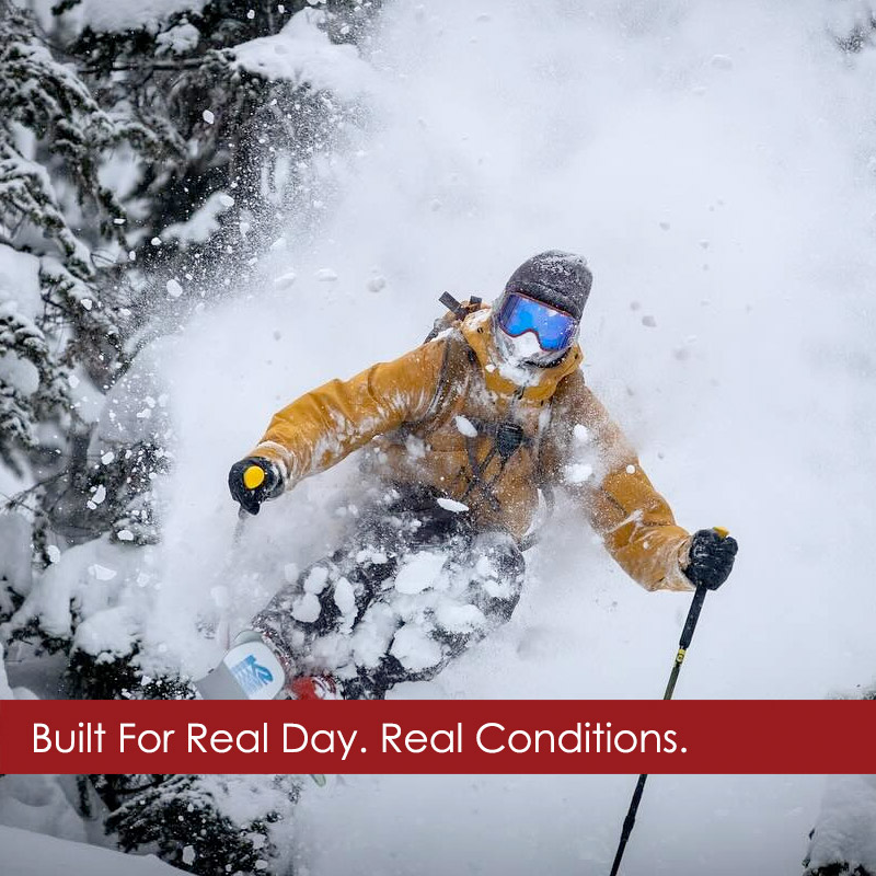 Man skiing powder in Beringia ski wear