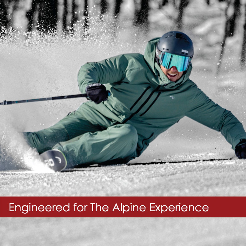 Kjus-Alpine-skiwear Man wearign KJUS skiwear green ski pants and jacket skiing on Aspen Mountain