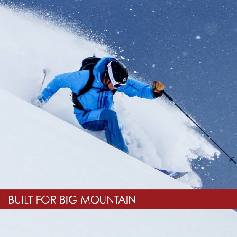 Man skiing powder wearing Norrona skiwear