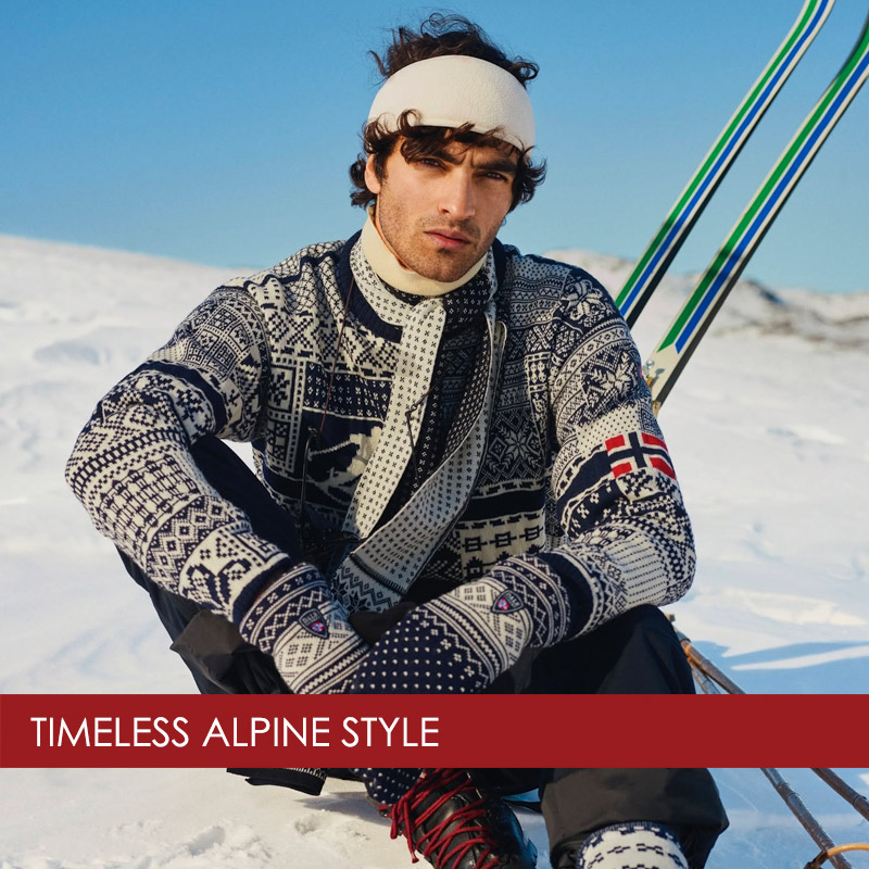 man-wearing-dale-of-norway-ski-sweater man wearing a Dale of Norway ski sweater sitting on ski slopes