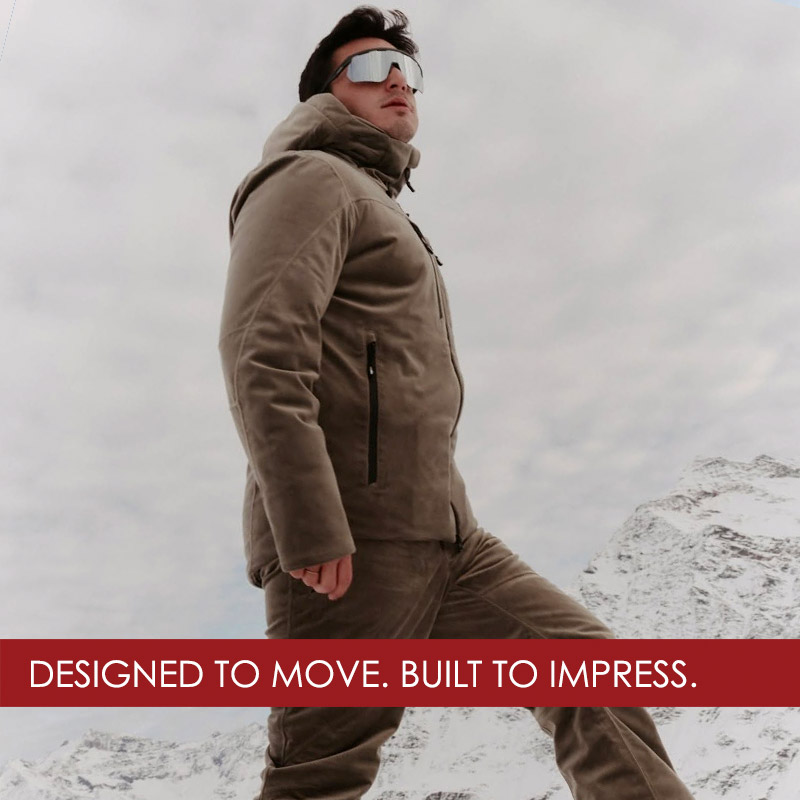 man wearing RH+ ski jacket and pants walking on snow