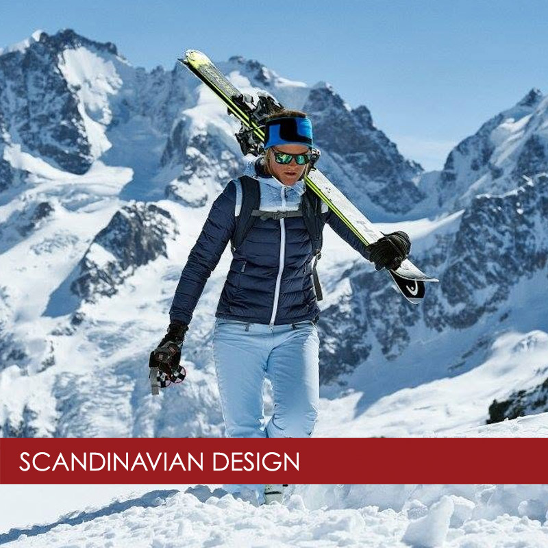 woman wearing J. Lindeberg skiwear with skis over her shoulder